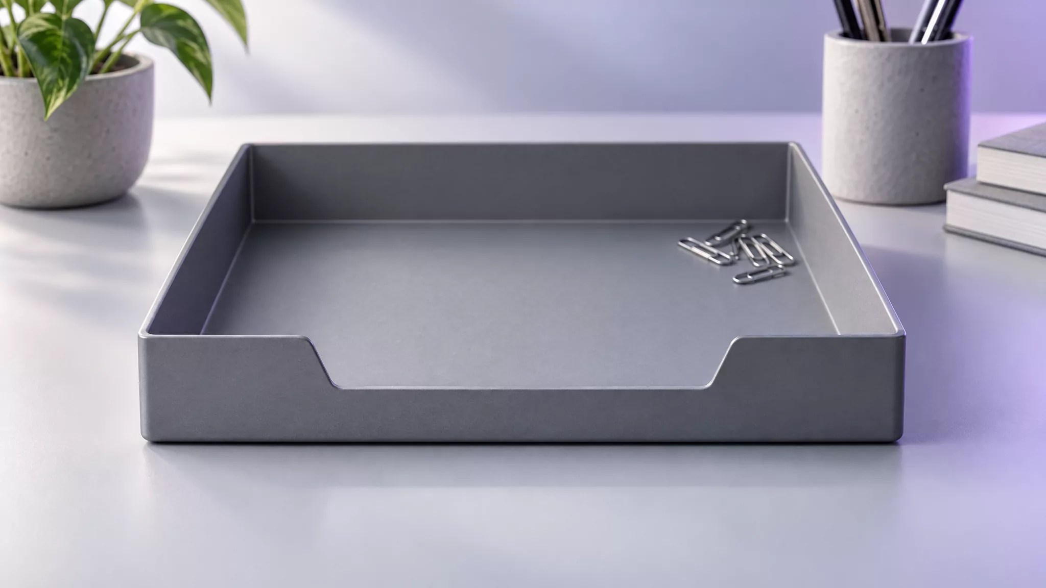 Empty grey desk tray with a few paper clips, standing for Chrome caches and preference files cleared away