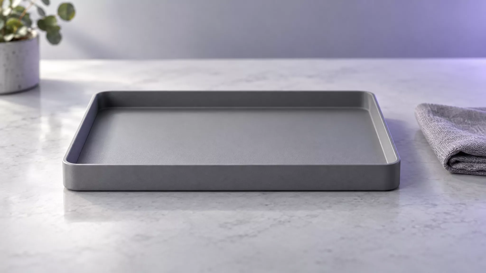 Empty grey desk tray on a clean surface, representing Steam preference and cache files cleared from the Mac Library