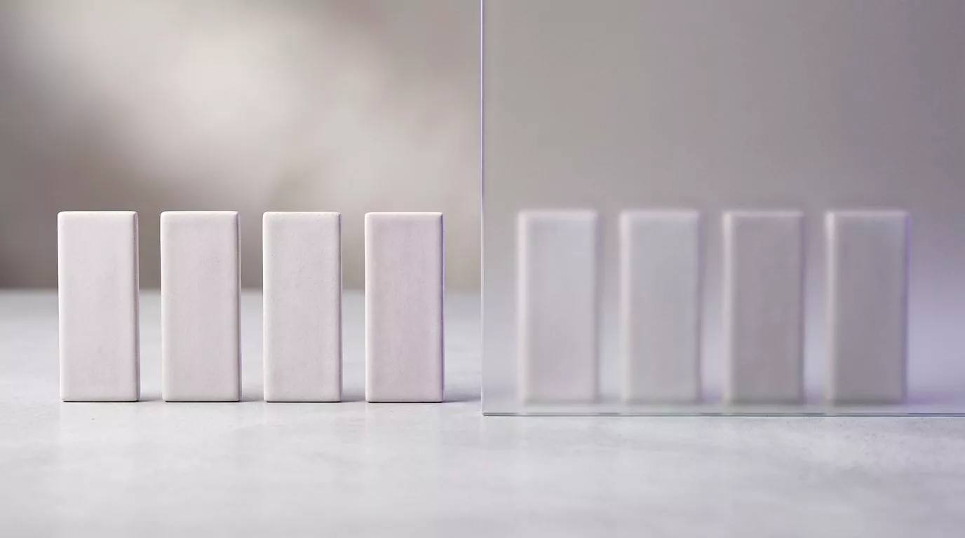 Four blocks in the open beside four identical blocks behind frosted glass, the free and paid CCleaner for Mac tiers